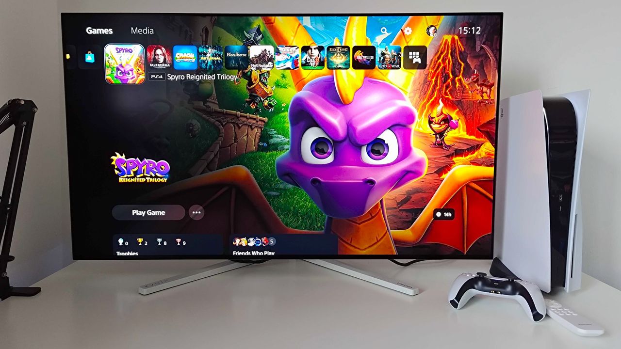 Philips Evnia 42M2N8900 monitor with PS5 menu on screen and Spyro the Dragon Reignited Trilogy art