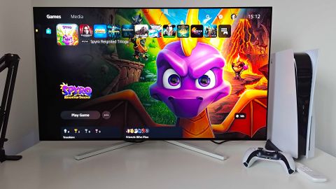Philips Evnia 42M2N8900 monitor with PS5 menu on screen and Spyro the Dragon Reignited Trilogy art 