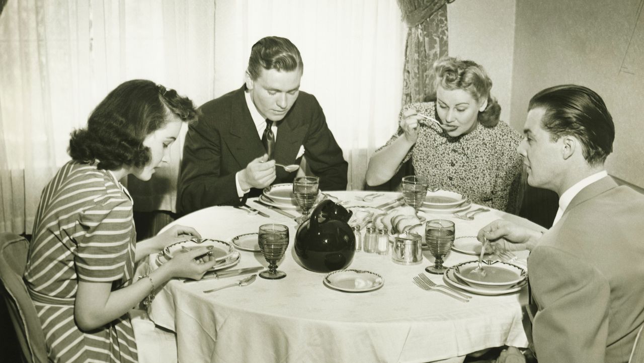 Two couples having dinner, (B&amp;W)