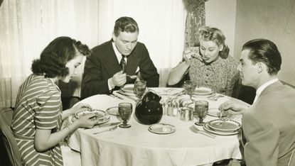 Two couples having dinner, (B&W)