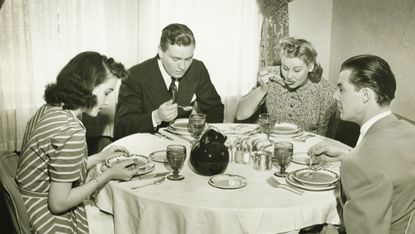 Two couples having dinner, (B&amp;W)