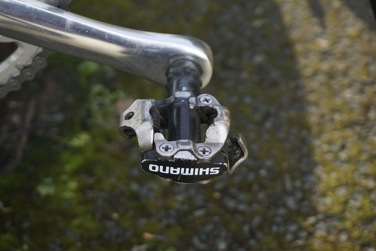 A close up of a silver gravel bike pedal