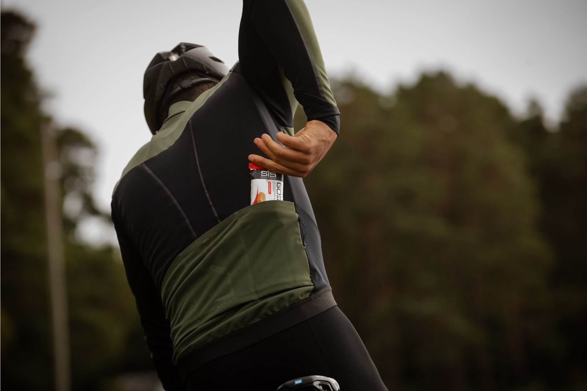 Image shows a cyclist consuming sugar on a bike ride