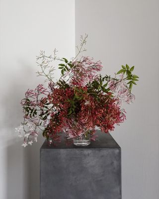 a fresh flower arrangement on a gray pedestal