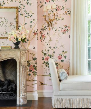 Pink floral mural wallpaper in grand millennial style living room with marble fireplace