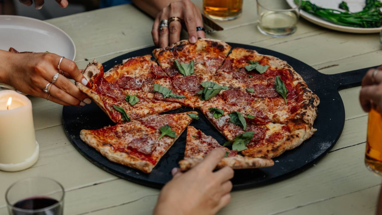 People sharing a pizza