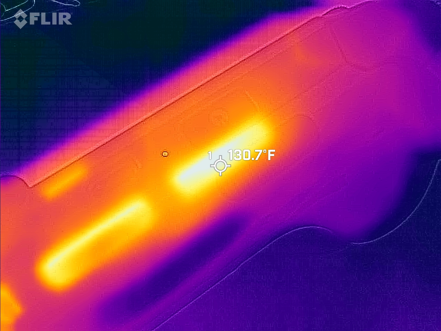 Macro thermal scan focused directly on the top exhaust vents, highlighting peak heat expulsion from the internal cooling system at a hot 130.7°F.