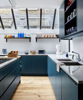 navy kitchen with white countertops