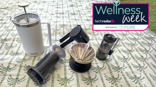 Five coffee makers on picnic blanket