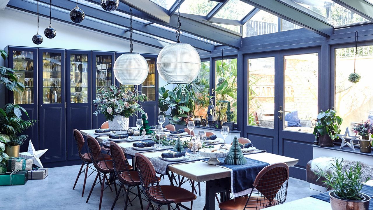 blue dining room with dining table and potted plants