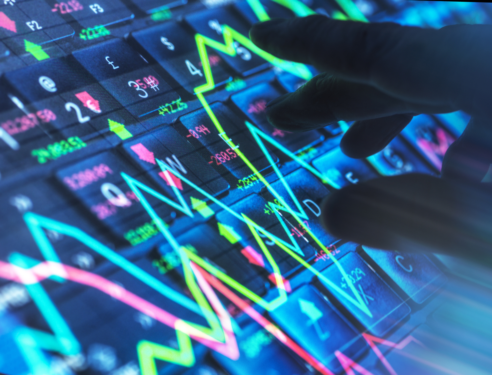 A hand interacting with stock market data on a digital screen