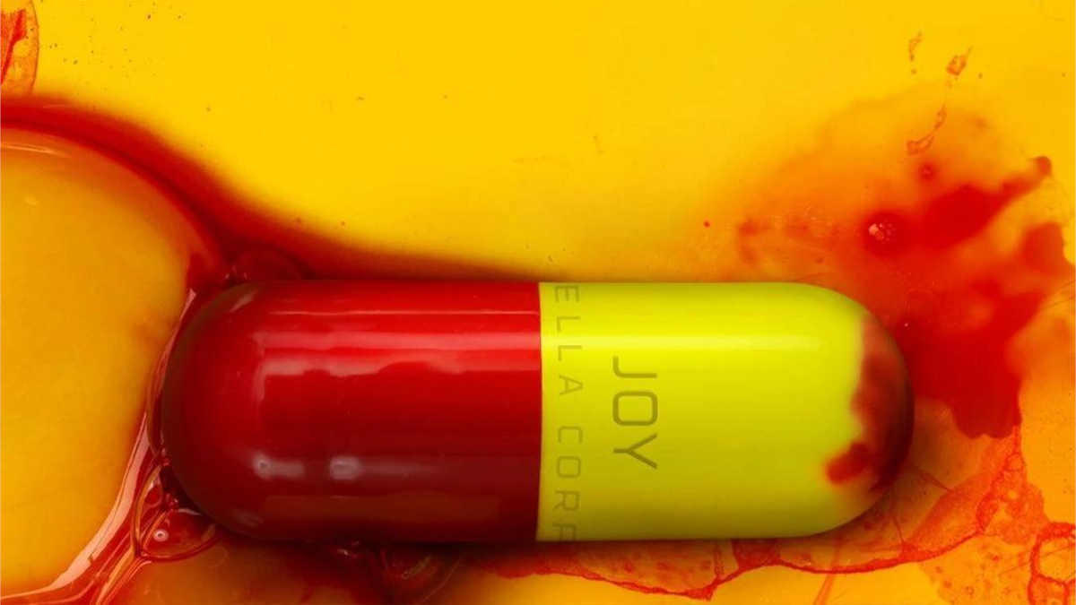 Red and yellow pill on yellow background 