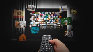 watching TV with remote control in hand