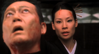 Lucy Liu with a severed head in Kill Bill