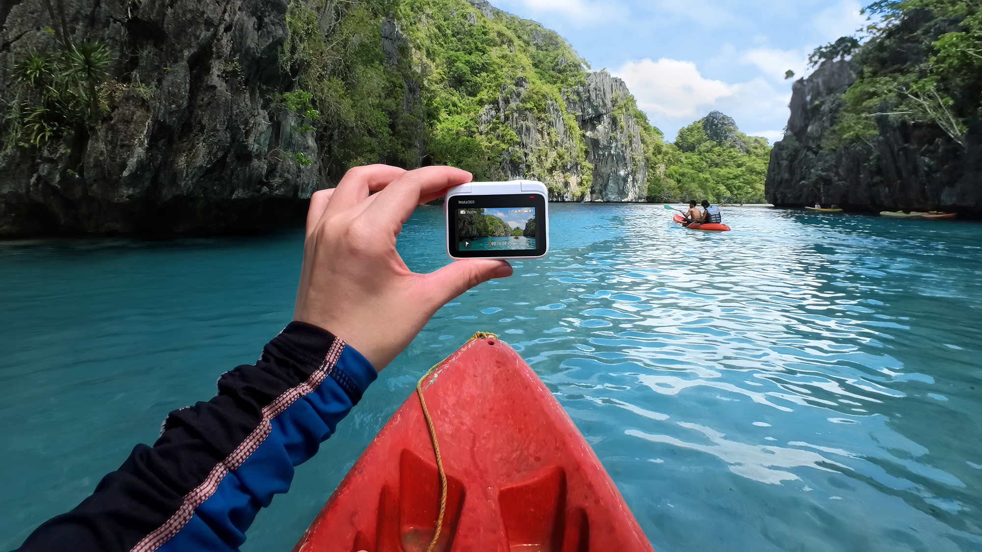 Insta360 Go 3 camera in the hand of a kayaker on a river