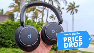 Anker Soundcore Space Q45 headphones placed in reviewer's hand with outdoors Florida scene in background