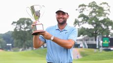 Scottie Scheffler with the Travelers Championship trophy 