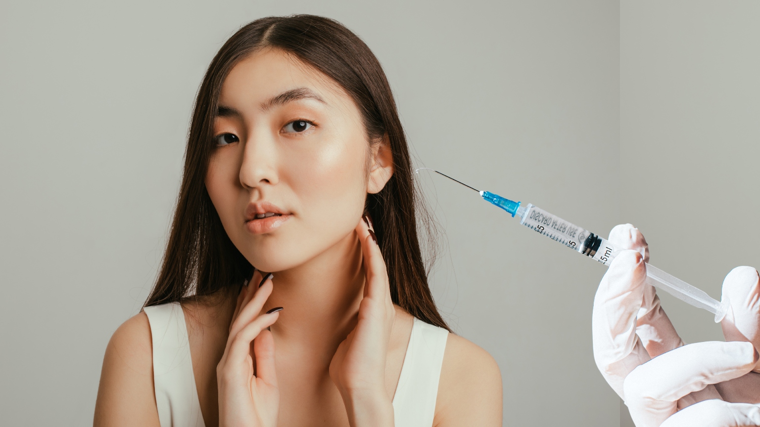 a young woman in a white tank top with dark hair next to a gloved hand holding a botox needle