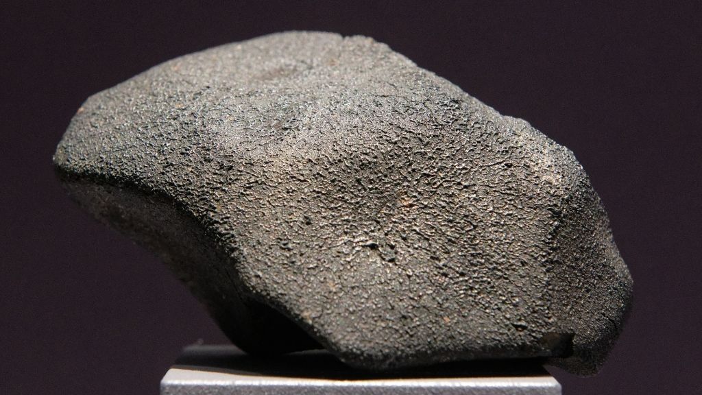 photo of the Murchison meteorite on a stand at a museum