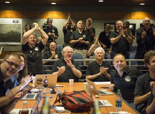The New Horizons science team reacts to receiving the spacecraft's sharpest image just before it flies by Pluto in July 2015.