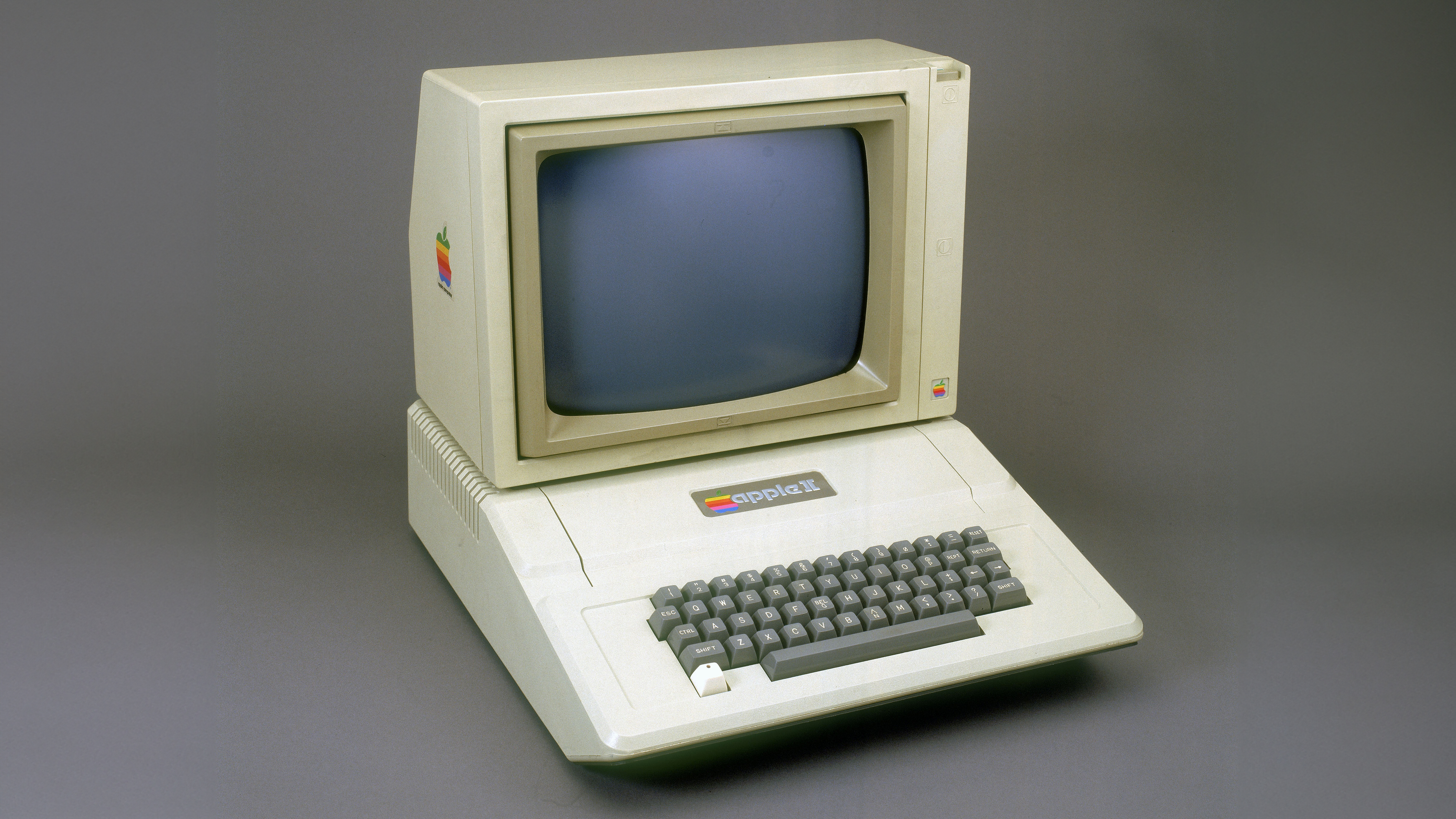 The Apple II computer sitting on a grey backdrop