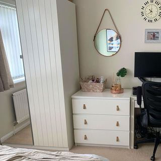 White chest of drawers next to a desk and chair