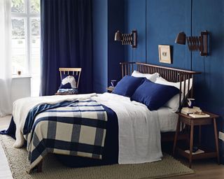 Blue bedroom, bed with spindle back headboard, bold check blanket