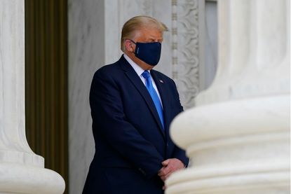 President Donald Trump wears a face mask while paying respects as Justice Ruth Bader Ginsburg lies in repose under the Portico at the top of the front steps of the U.S. Supreme Court building