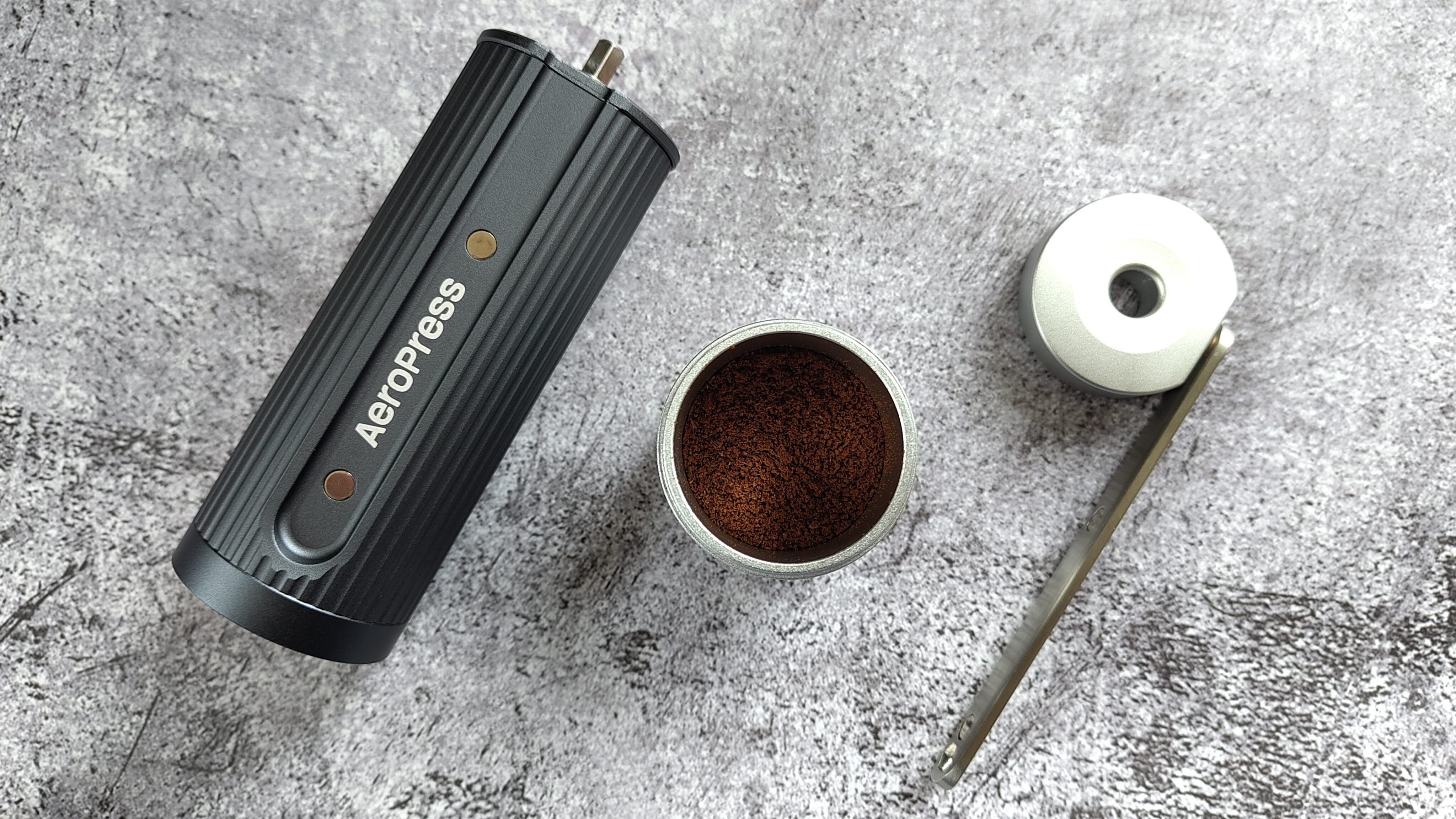 Aeropress manual coffee grinder with freshly-ground coffee