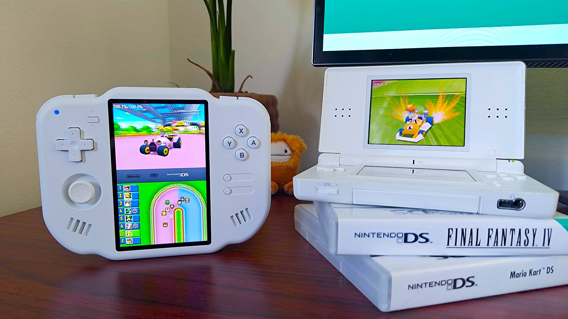 MagicX Zero 40 on left and Nintendo DS Lite on top of game cases with both handhelds running Mario Kart DS.