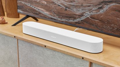 Sonos Beam 2 soundbar on wooden TV cabinet