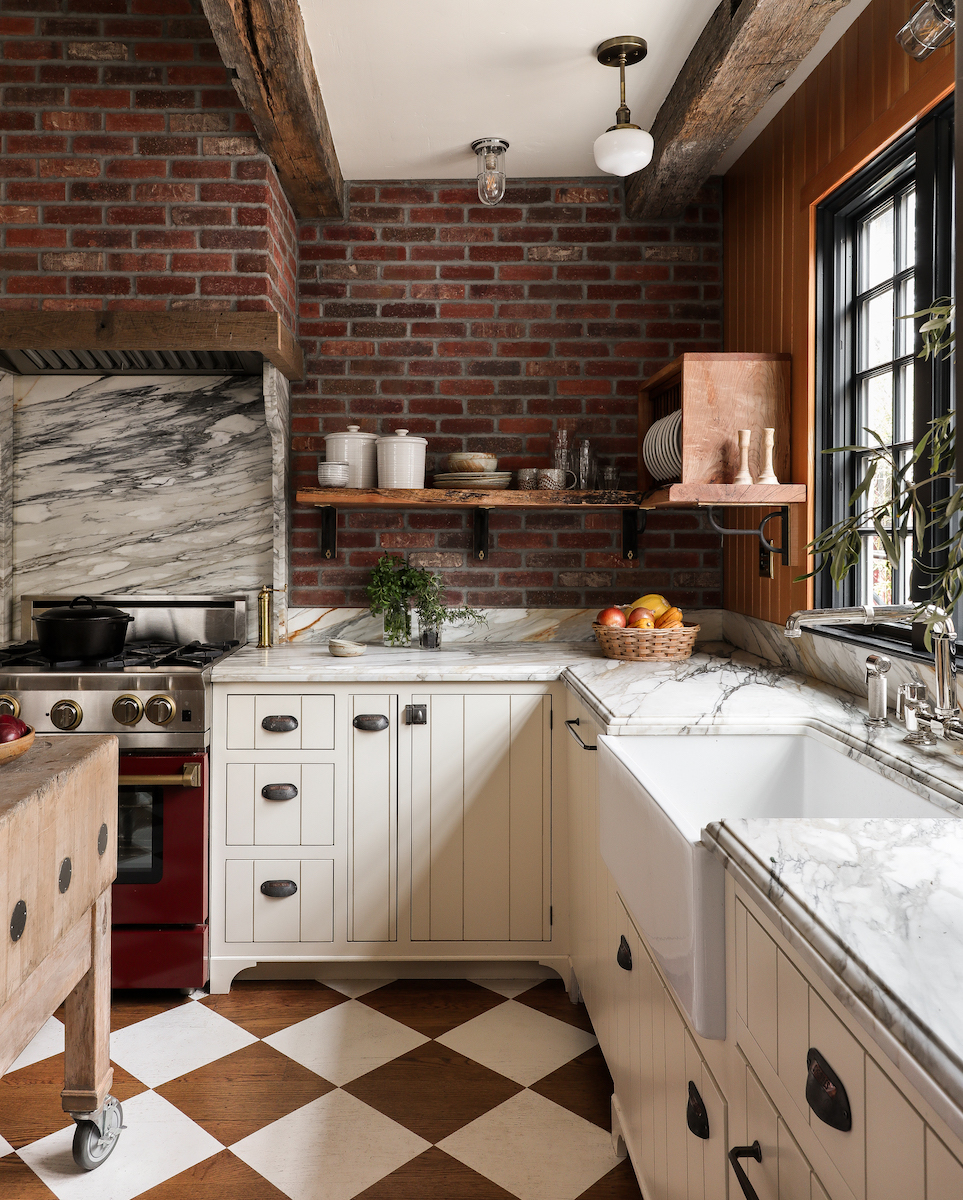 A close-up of a San Francisco kitchen&#039;s marble counters and exposed brick walls.