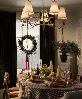 A Christmas wreath hung on a dining room window