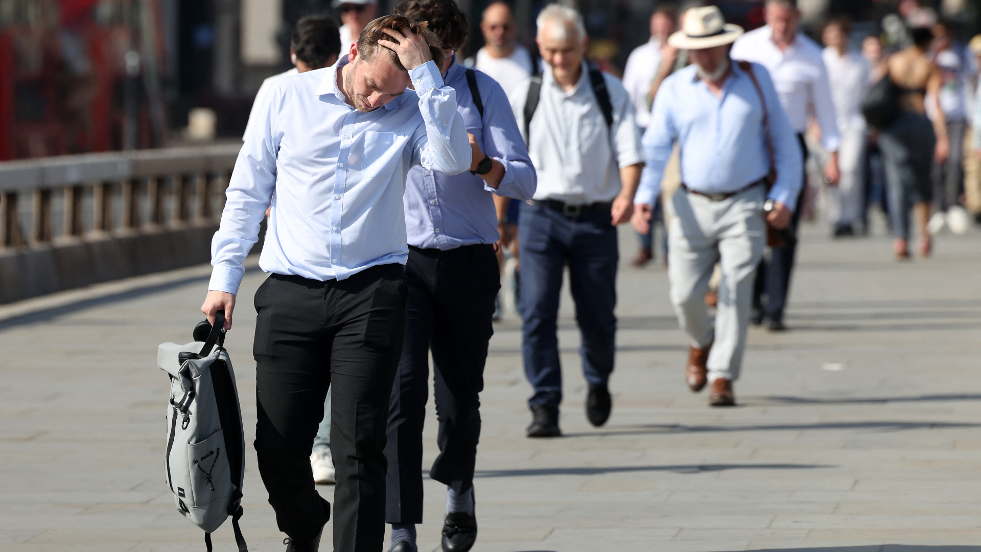 Commuters walk in the sun as they cross London Bridge , during a heatwave, in central London on June 24, 2026. The UK recorded its hottest ever June temperature
