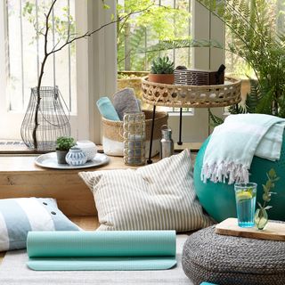 living room with printed cushions and plant in vase