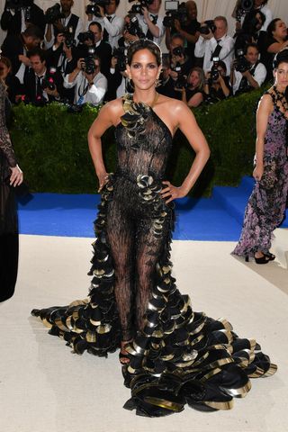 Halle Berry wears a black dress with gold detailing at the 'Rei Kawakubo/Comme des Garcons: Art Of The In-Between' Costume Institute Gala at Metropolitan Museum of Art on May 1, 2017 in New York City.