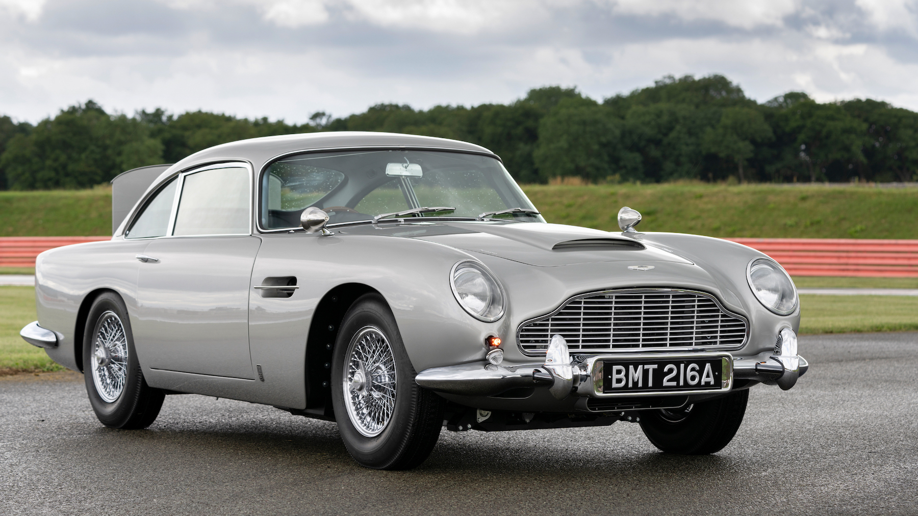 Aston Martin DB5 driving on a country road