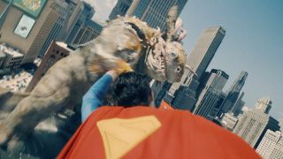 Superman (David Corenswet) charges towards a monster in Superman
