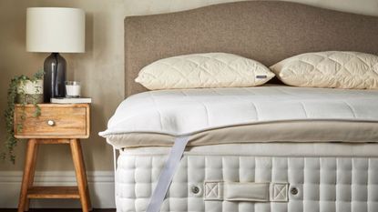 Do I need to flip my mattress topper: A Woolroom mattress topper on bed lifestyle image with neutral scheme 