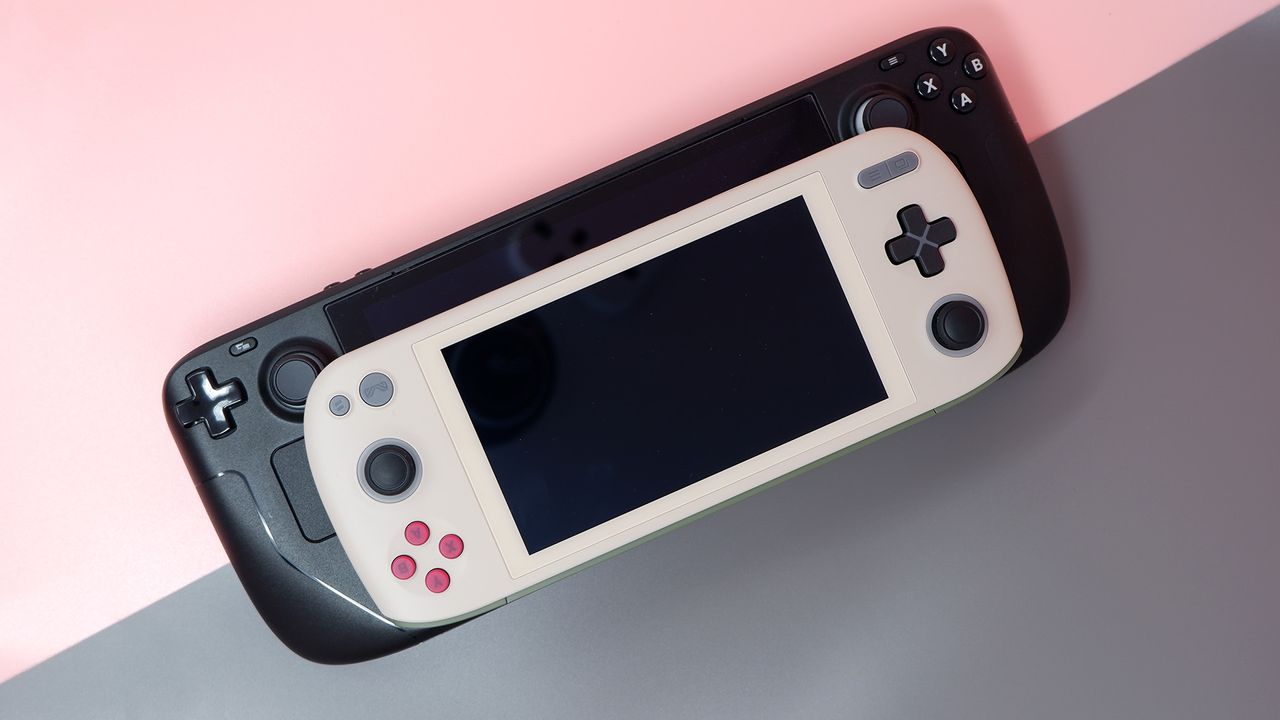 Ayaneo Air 1S handheld gaming PC on a pink background.