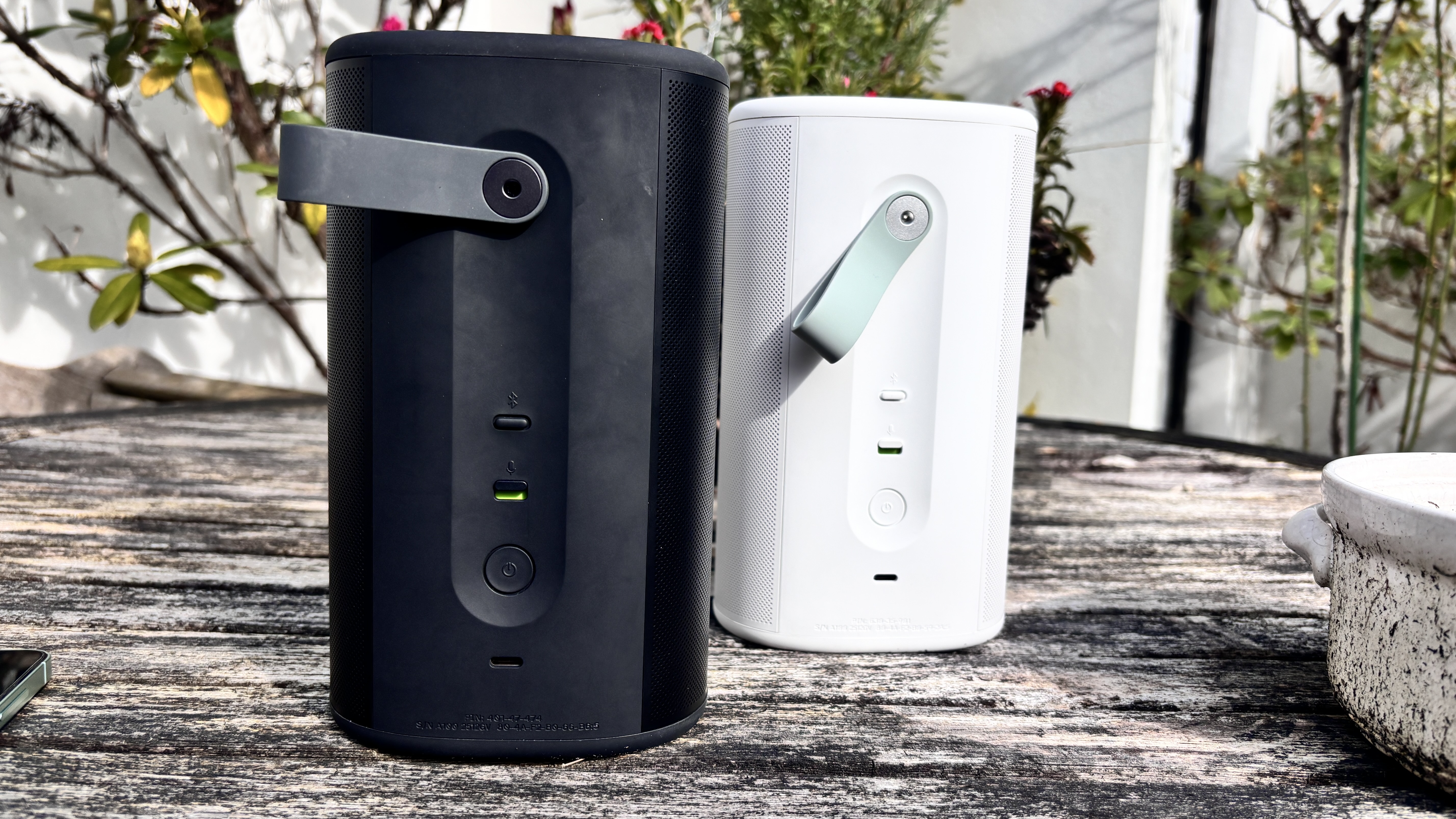 Two Sonos Play wireless speakers next to each other, one in black and the other in white