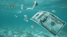 $100 bills float in water.