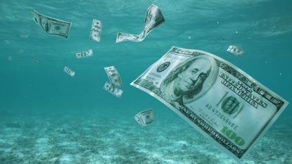 $100 bills float in water.