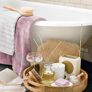 bathroom with white bathtub and massager