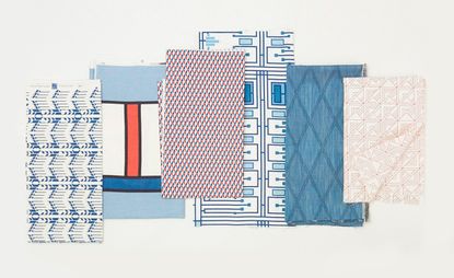 Fabrics with different geometric patterns laid on top of each other.