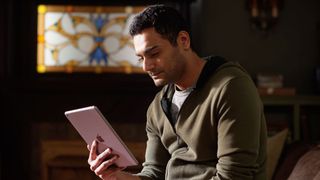 Hamza Haq as Dr. Bashir Hamed looking at a tablet in Tranplant season 3
