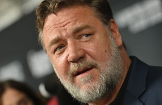 a close up of Russell Crowe who appeared in Neighbours