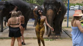 Porsha taking a selfie in front of an elephant in RHUGT season 3