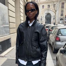 Sylvie Mus in Paris wearing a leather jacket and denim pencil skirt.