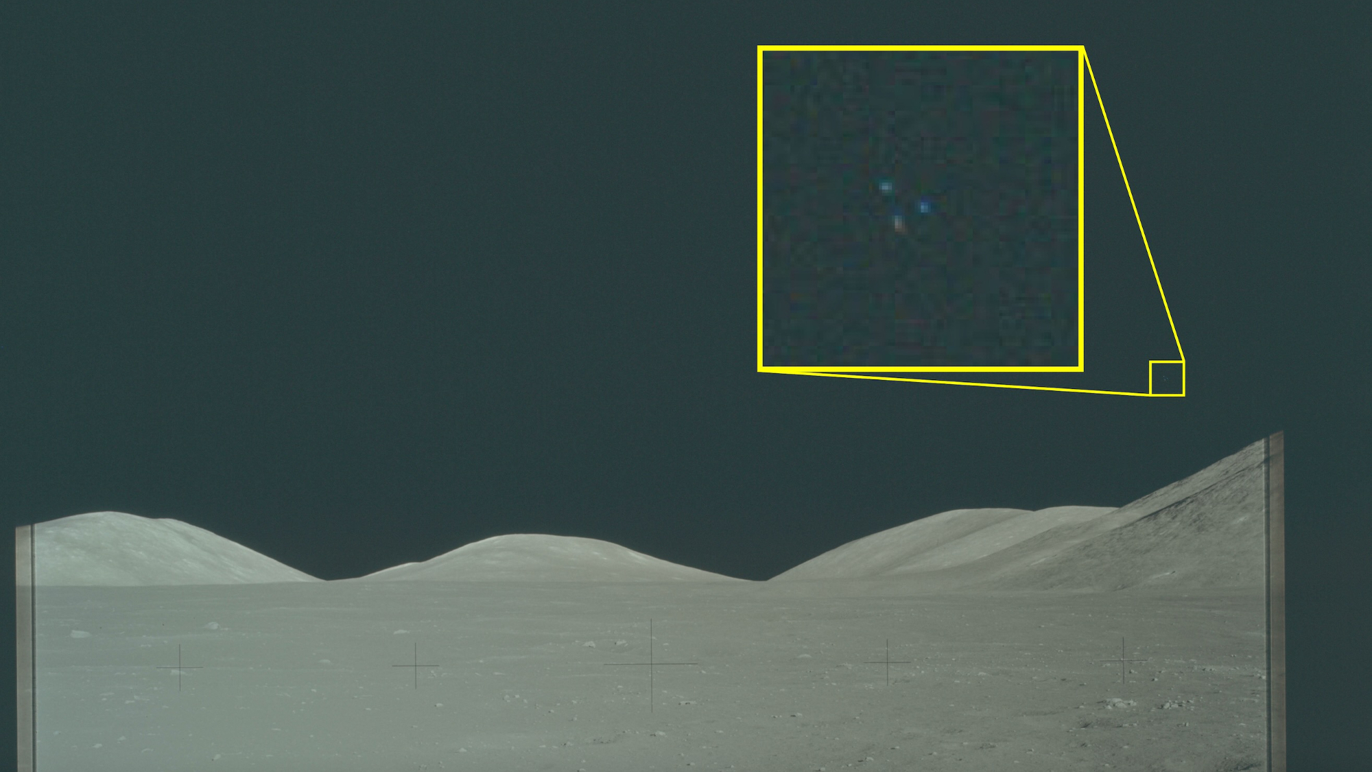 photo snapped on the surface of the moon, showing gray dirt and black skies above